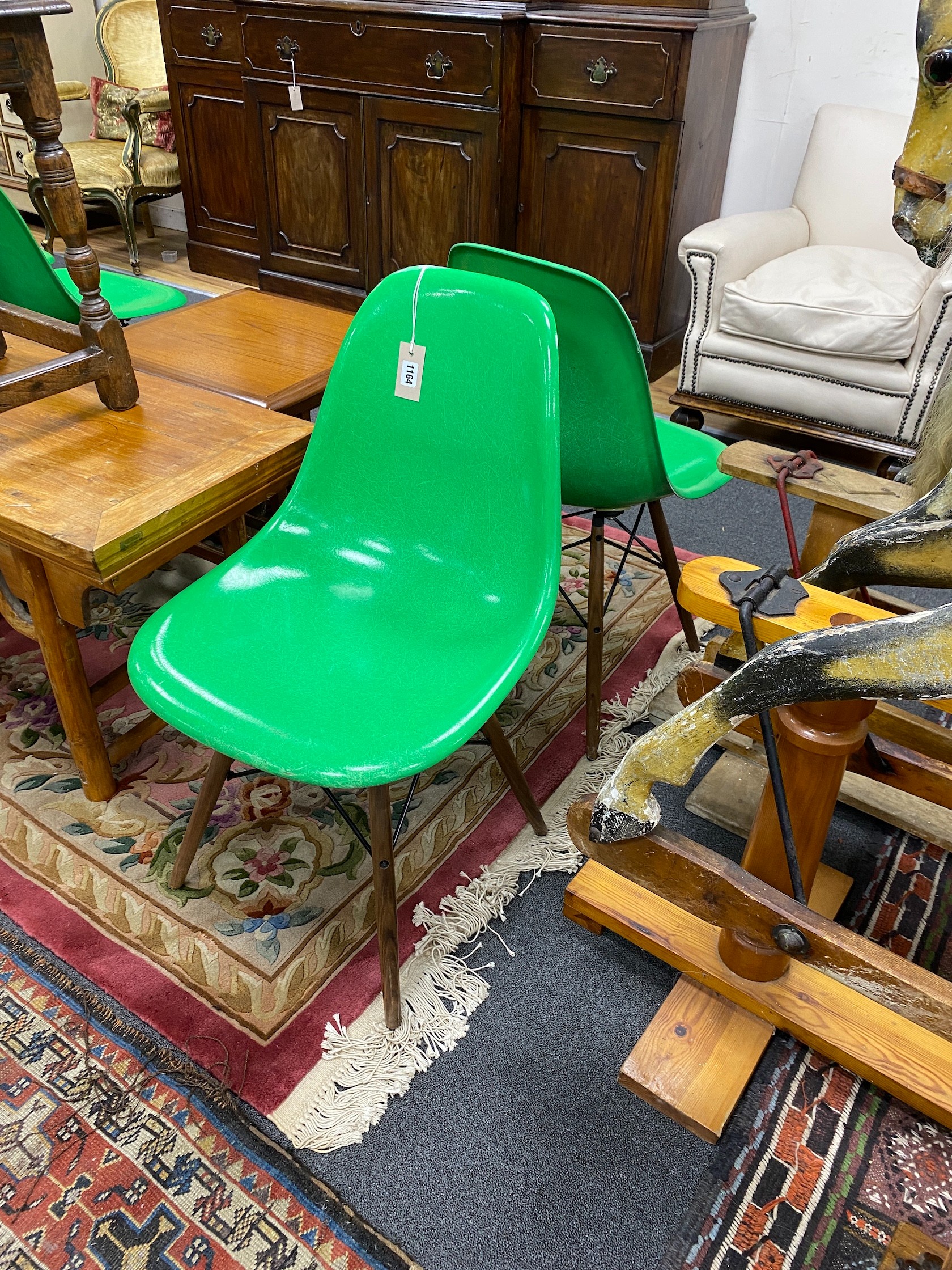 A set of six green Eames chairs